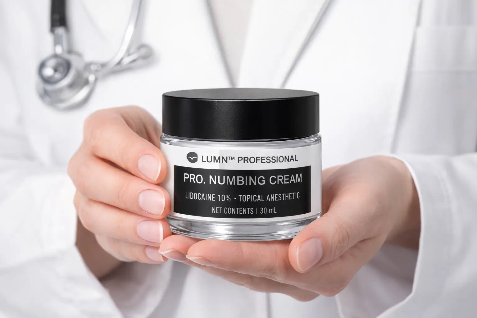 dermatologist holding lumni professional lidocaine numbing cream used before microneedling treatments